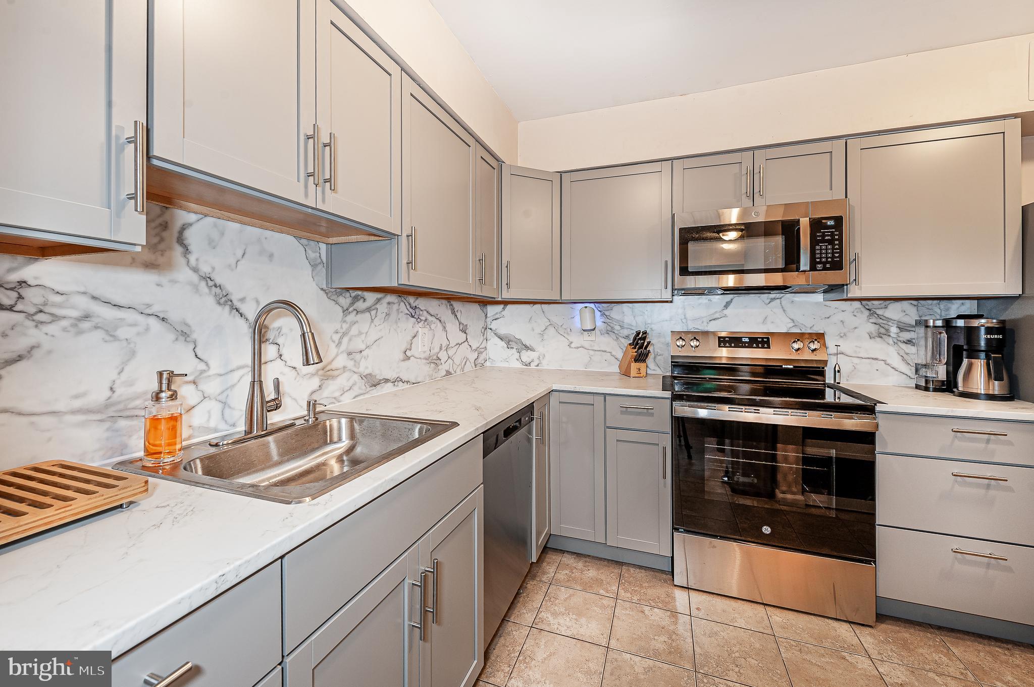 41 Noble Road Sicklerville, NJ 08081 - Photo 7 of 18 a kitchen with stainless steel appliances granite countertop a sink and a stove