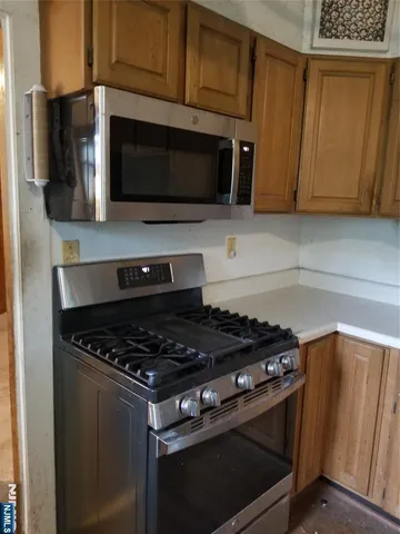 a bathroom with a toilet a window and tub