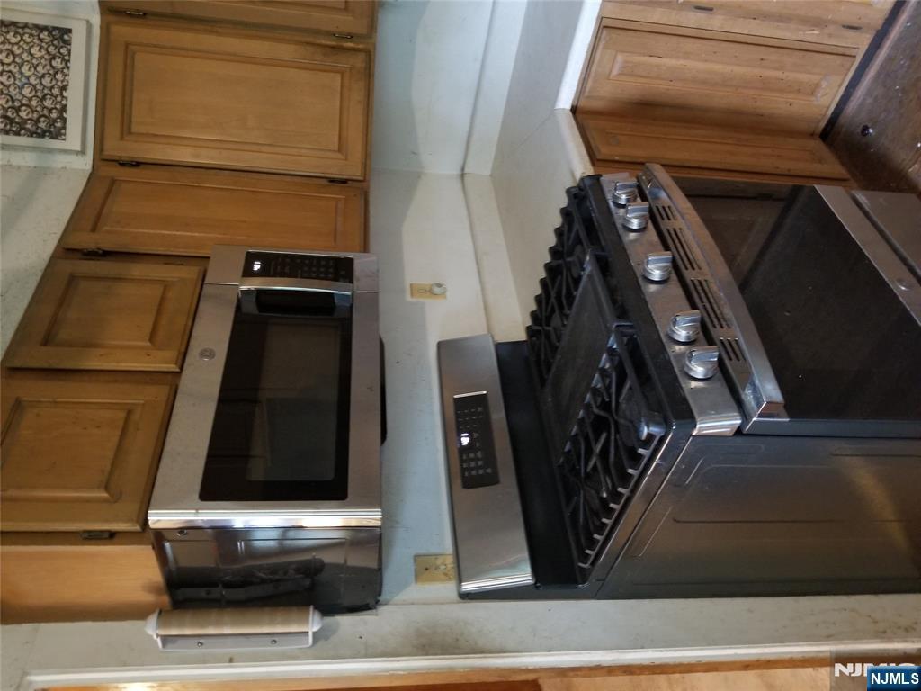734 Broad Street Bloomfield, NJ 07003 - Photo 12 of 23 a kitchen with stainless steel appliances a sink stove and microwave