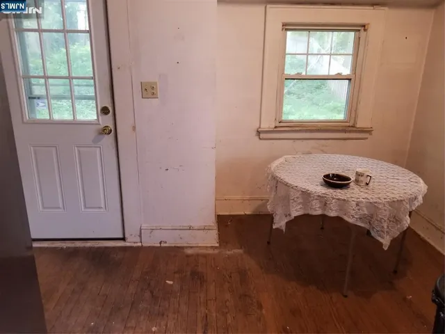a room with wooden floor and a window