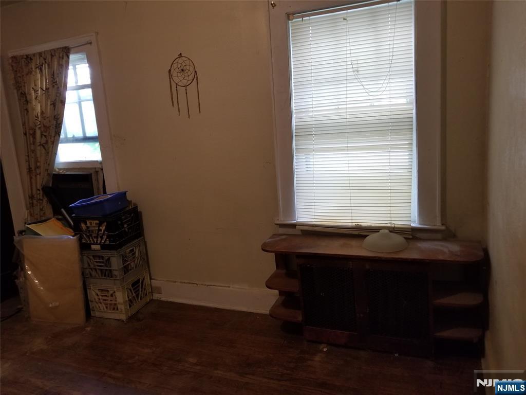 734 Broad Street Bloomfield, NJ 07003 - Photo 18 of 23 a room with wooden floor and a window