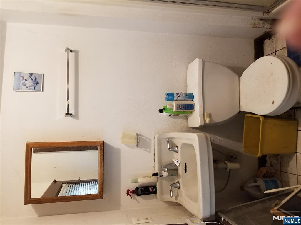 734 Broad Street Bloomfield, NJ 07003 - Photo 22 of 23 a white toilet sitting next to a bathroom sink