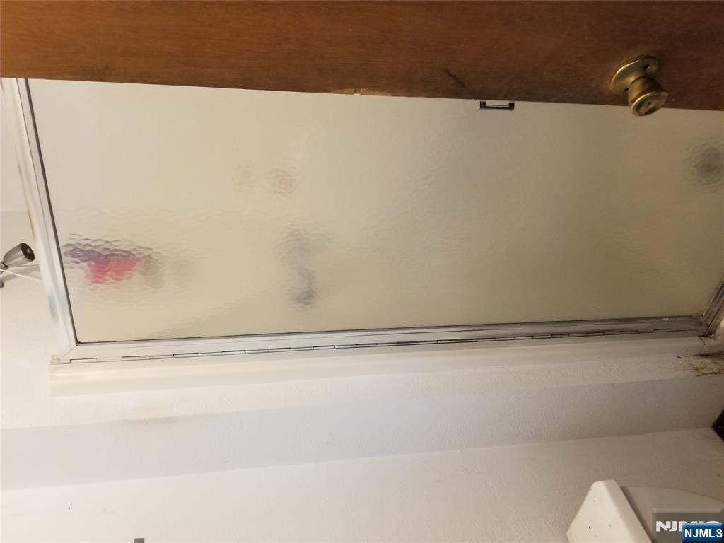 734 Broad Street Bloomfield, NJ 07003 - Photo 23 of 23 a bathroom with a glass shower door