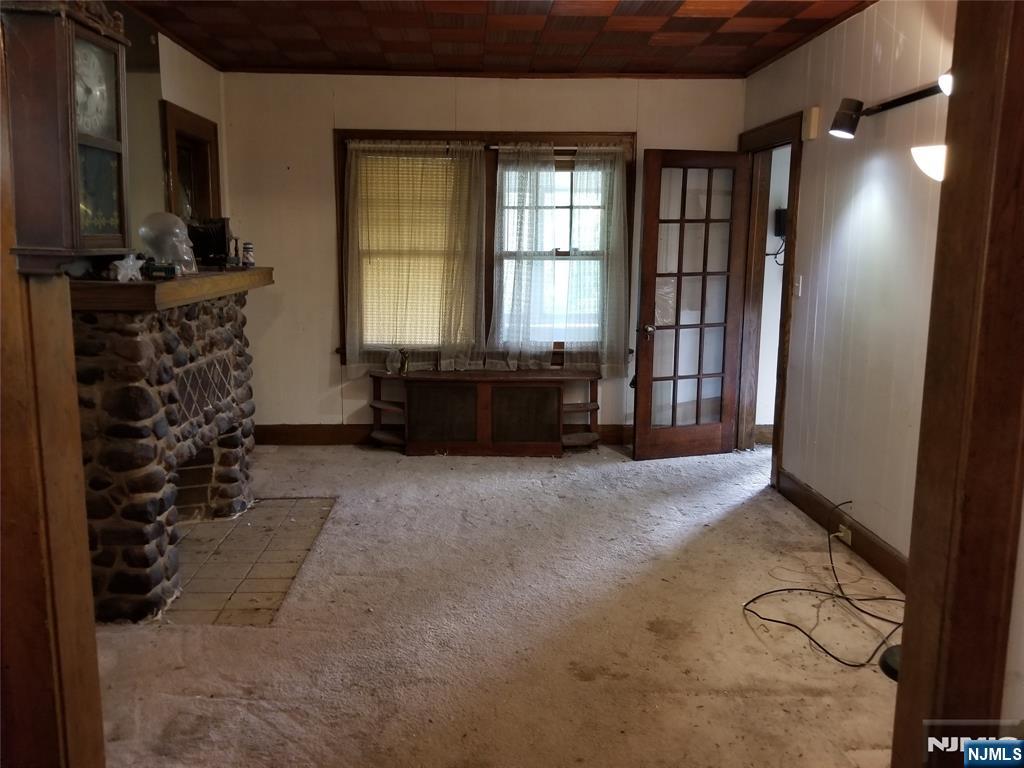 734 Broad Street Bloomfield, NJ 07003 - Photo 5 of 23 a living room with furniture a window and a flat screen tv