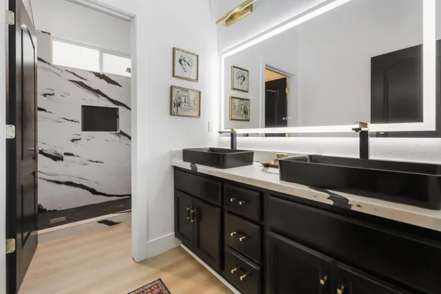 a bathroom with a double vanity sink and mirror