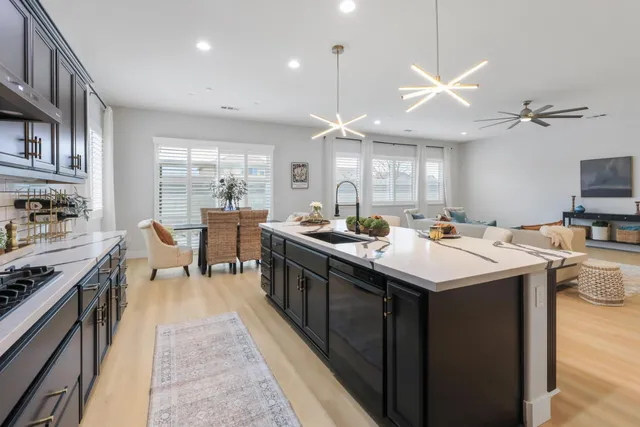 a kitchen with counter top space a sink appliances and cabinets