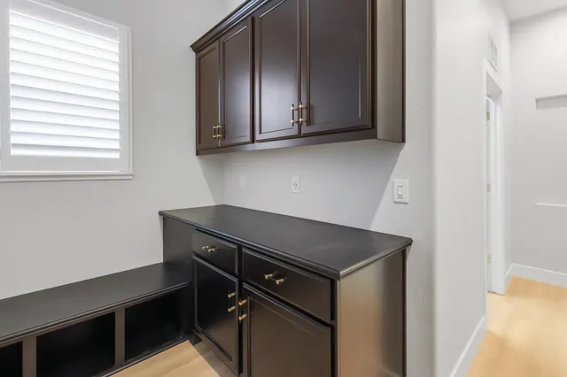 a utility room with wooden floor washer and dryer