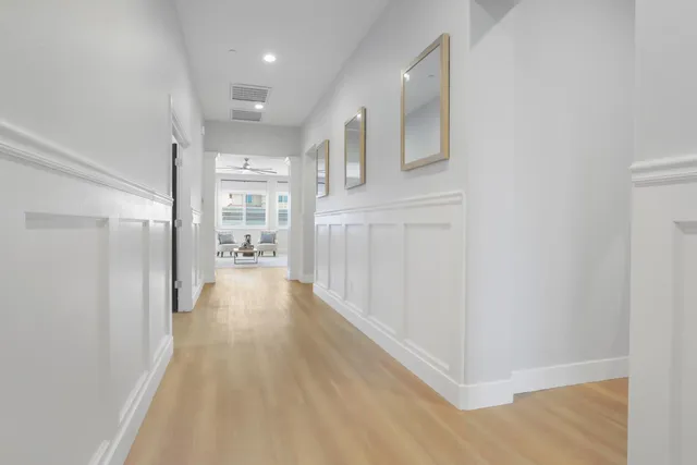 a view of a hallway with wooden floor