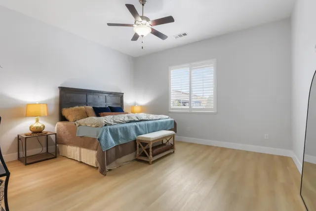 a bedroom with a bed and a chandelier