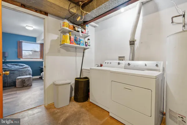 a utility room with a sink dryer and washer