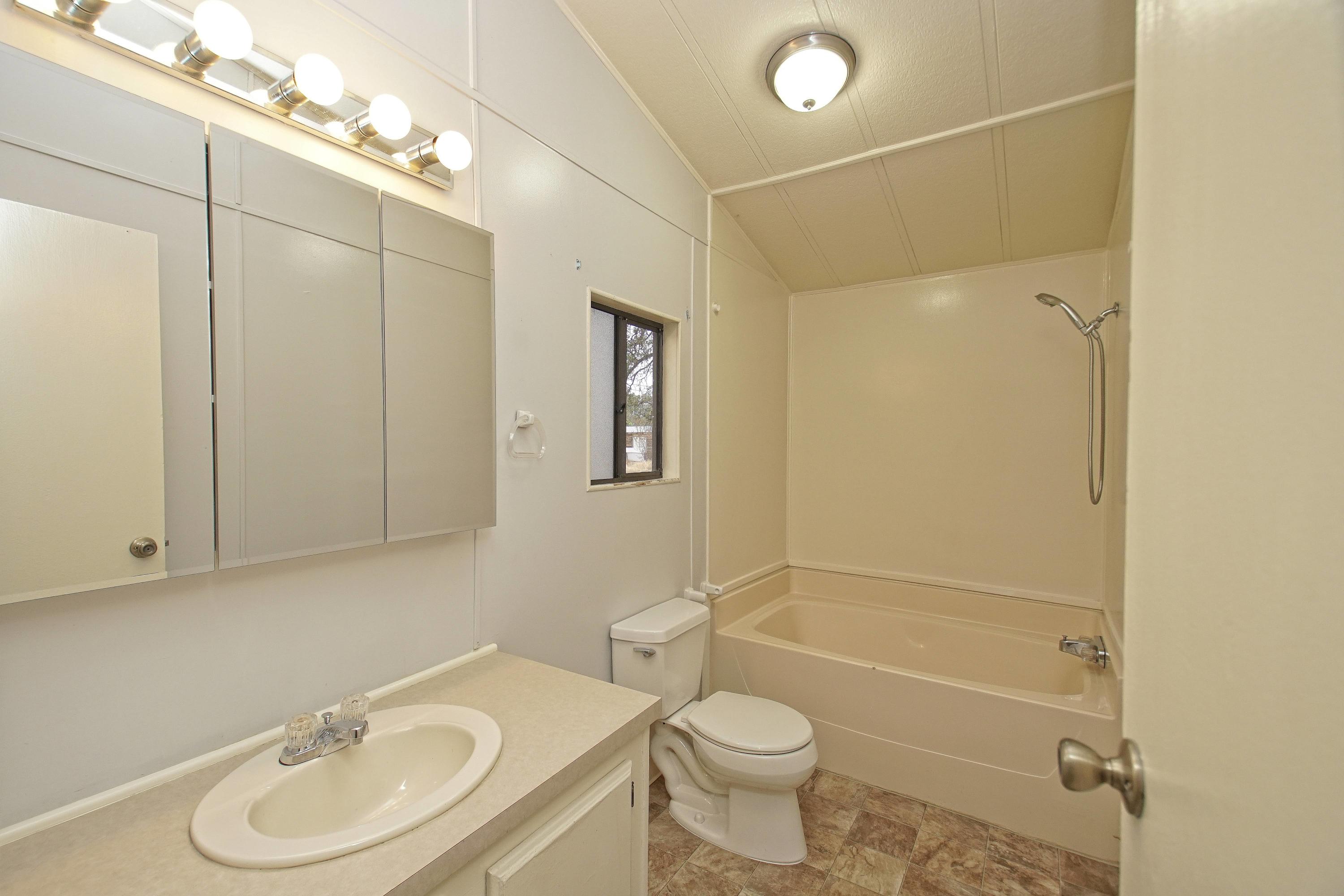 11831 Scott Road Redding, CA 96003 - Photo 12 of 22 a bathroom with a sink a toilet and shower