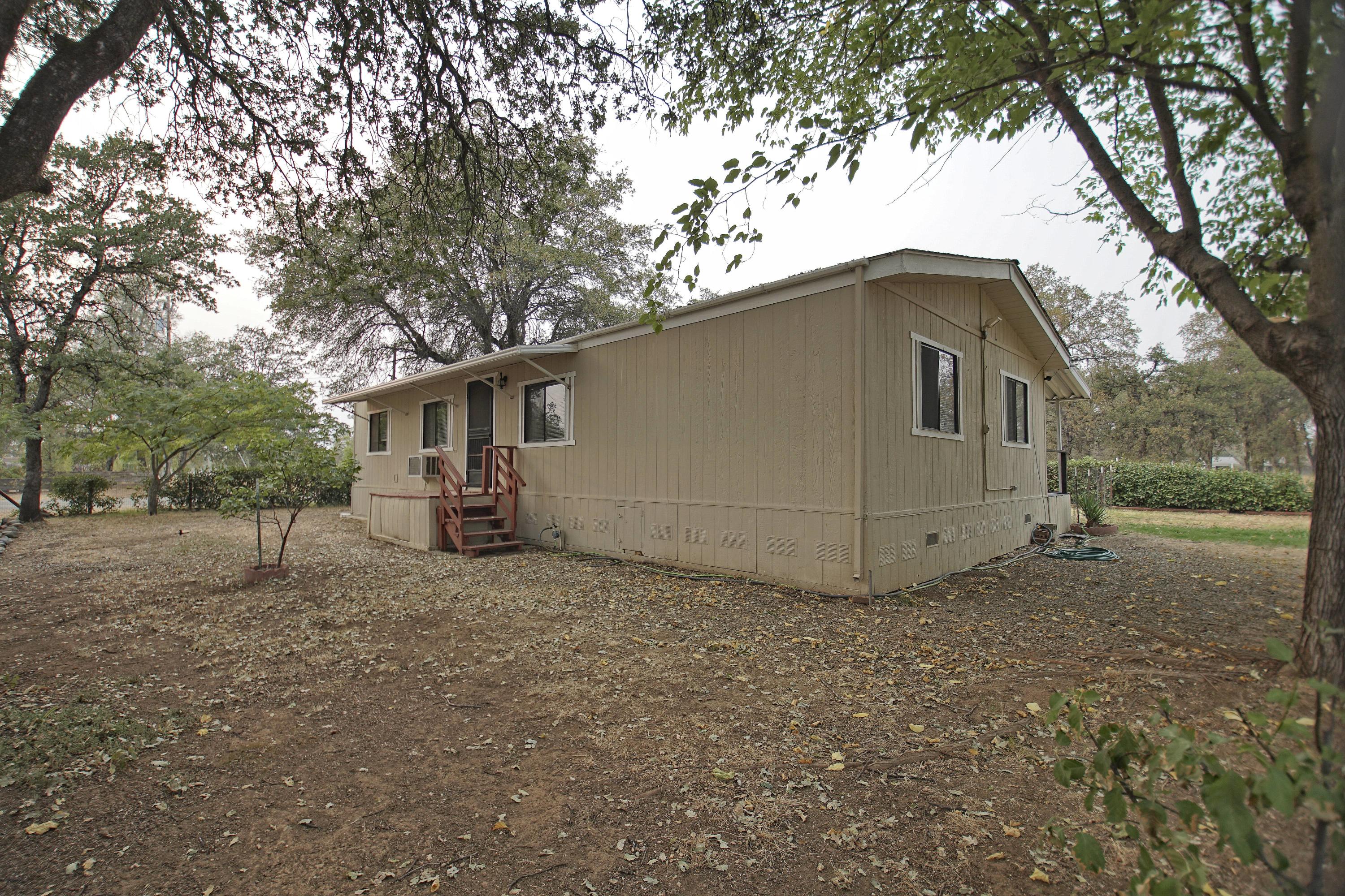 11831 Scott Road Redding, CA 96003 - Photo 21 of 22 a white house that has a tree in front of it