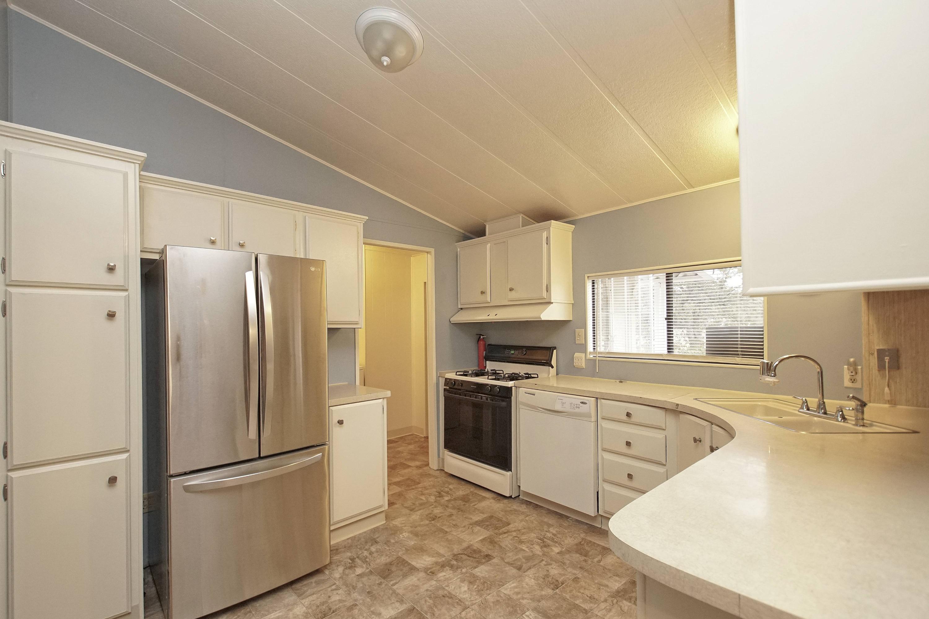11831 Scott Road Redding, CA 96003 - Photo 4 of 22 a kitchen with stainless steel appliances a refrigerator sink and microwave