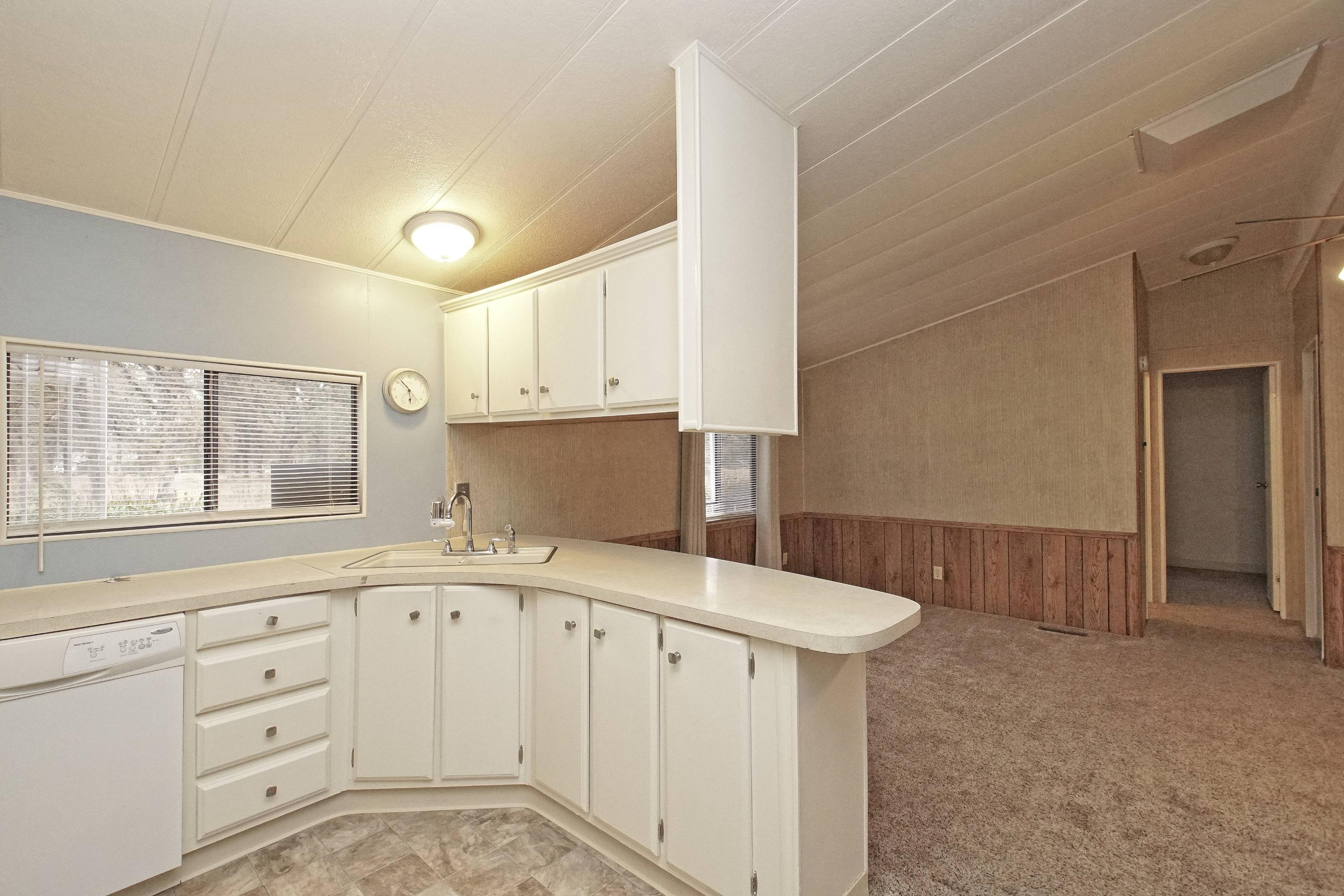 11831 Scott Road Redding, CA 96003 - Photo 6 of 22 a kitchen with a sink cabinets and window