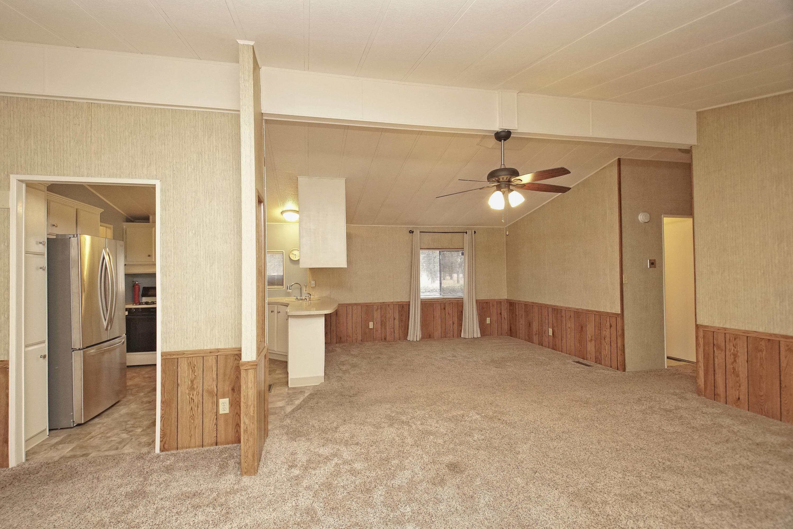 11831 Scott Road Redding, CA 96003 - Photo 7 of 22 a view of a kitchen with a refrigerator cabinets and a wooden floor