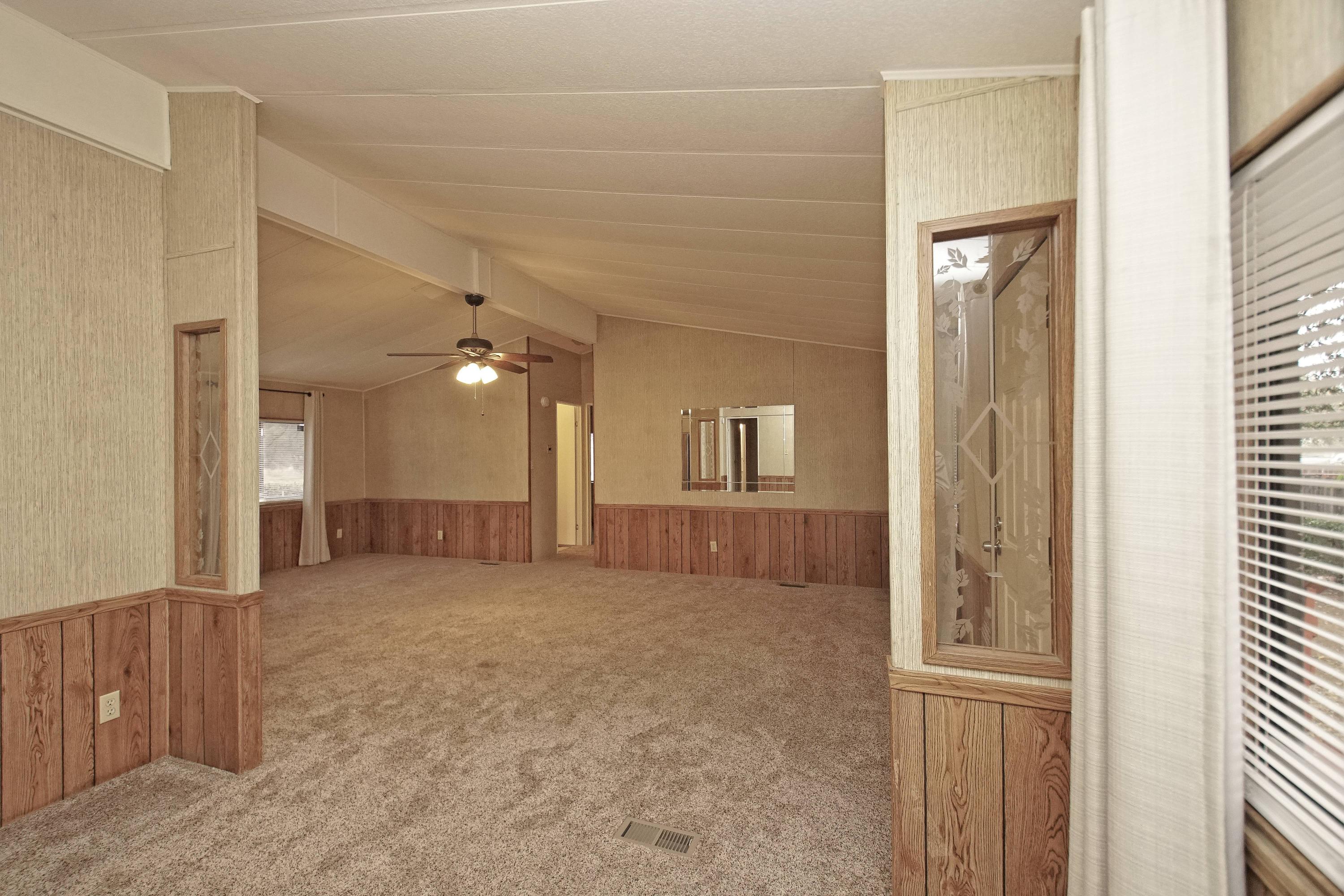 11831 Scott Road Redding, CA 96003 - Photo 8 of 22 a view of a big room with windows and chandelier fan