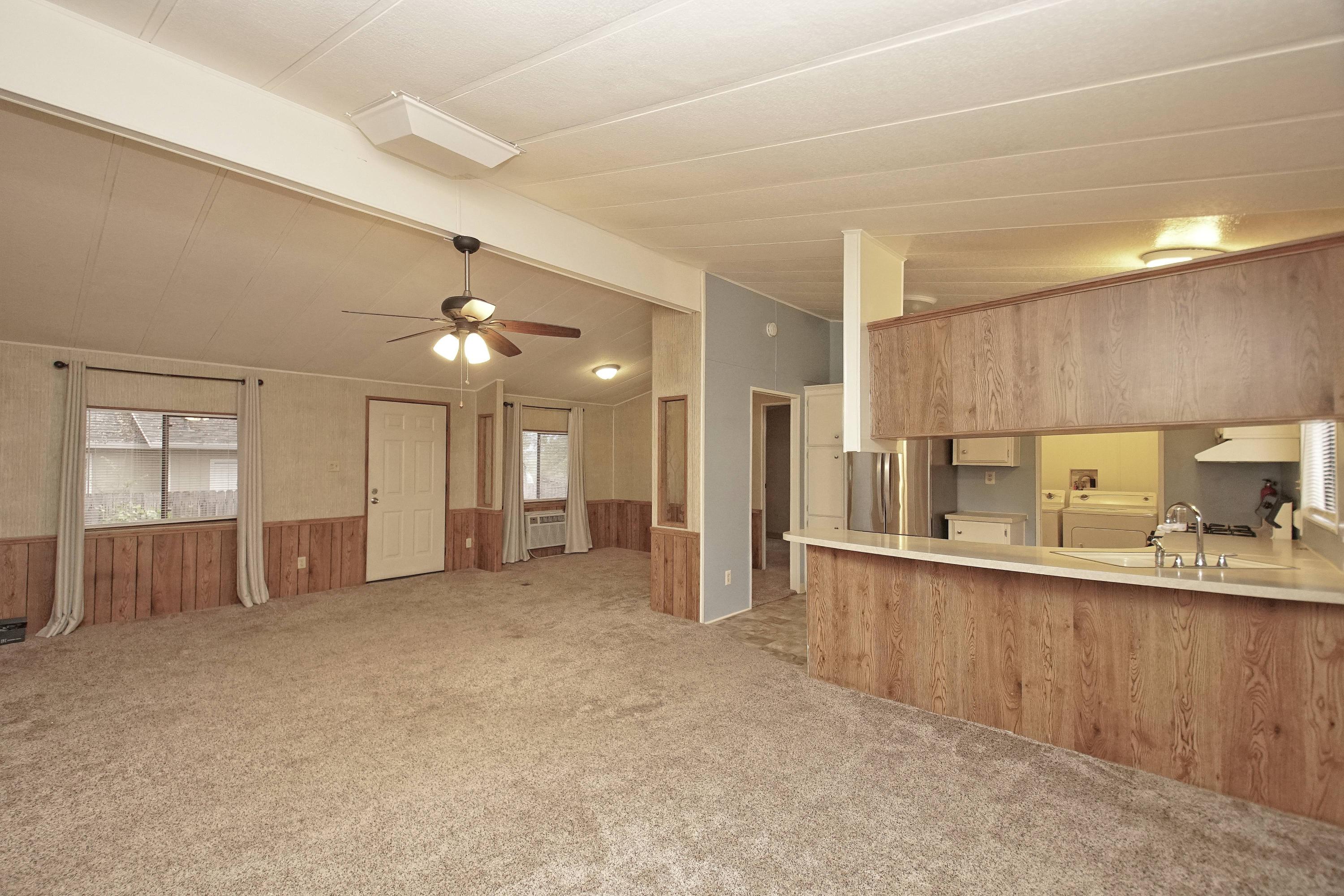 11831 Scott Road Redding, CA 96003 - Photo 10 of 22 a large living room with a large window and furniture