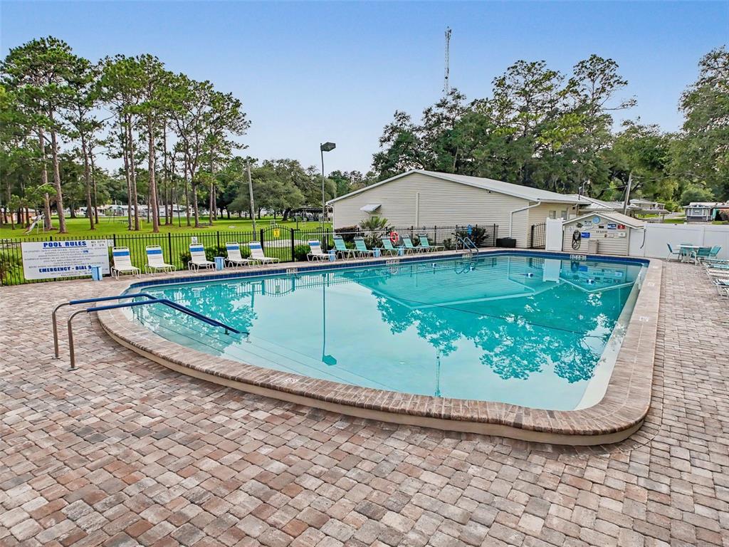 2092 Culbreath Road, Unit A42 Brooksville, FL 34602 - Photo 39 of 70 a view of a swimming pool with a outdoor seating
