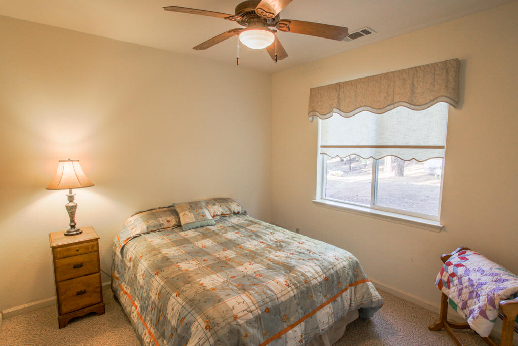 12855 Fern Road Whitmore, CA 96096 - Photo 14 of 45 a bedroom with a bed and a window
