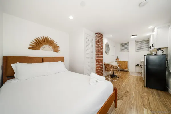 a bedroom with a bed and wooden floor