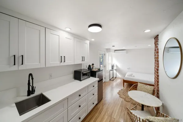 a kitchen with sink cabinets and living room