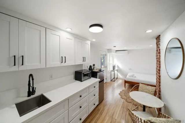 a kitchen with sink cabinets and living room