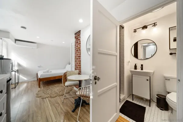 a bathroom with a sink a toilet and a mirror