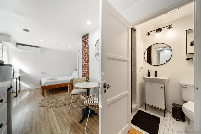 a bathroom with a sink a toilet and a mirror