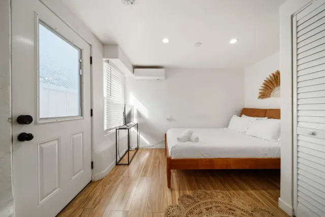 a bedroom with a bed and a table