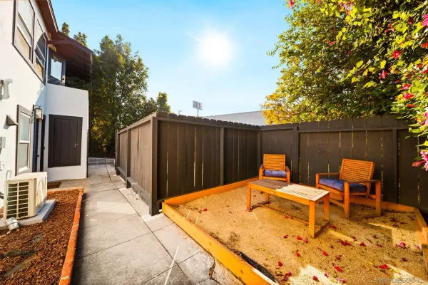 a backyard of a house with table and chairs