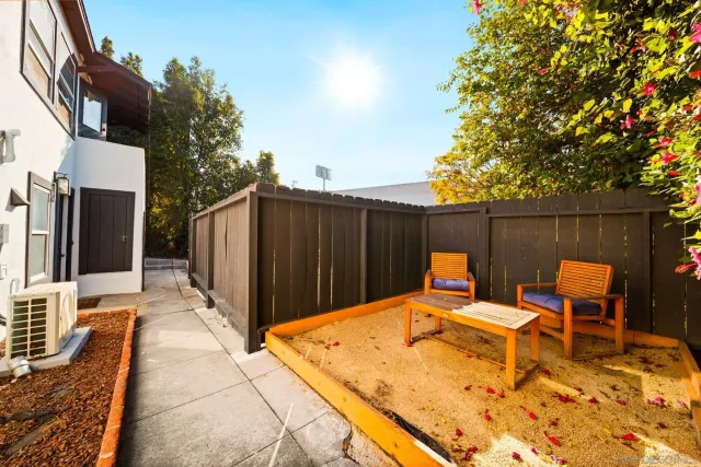 a backyard of a house with table and chairs