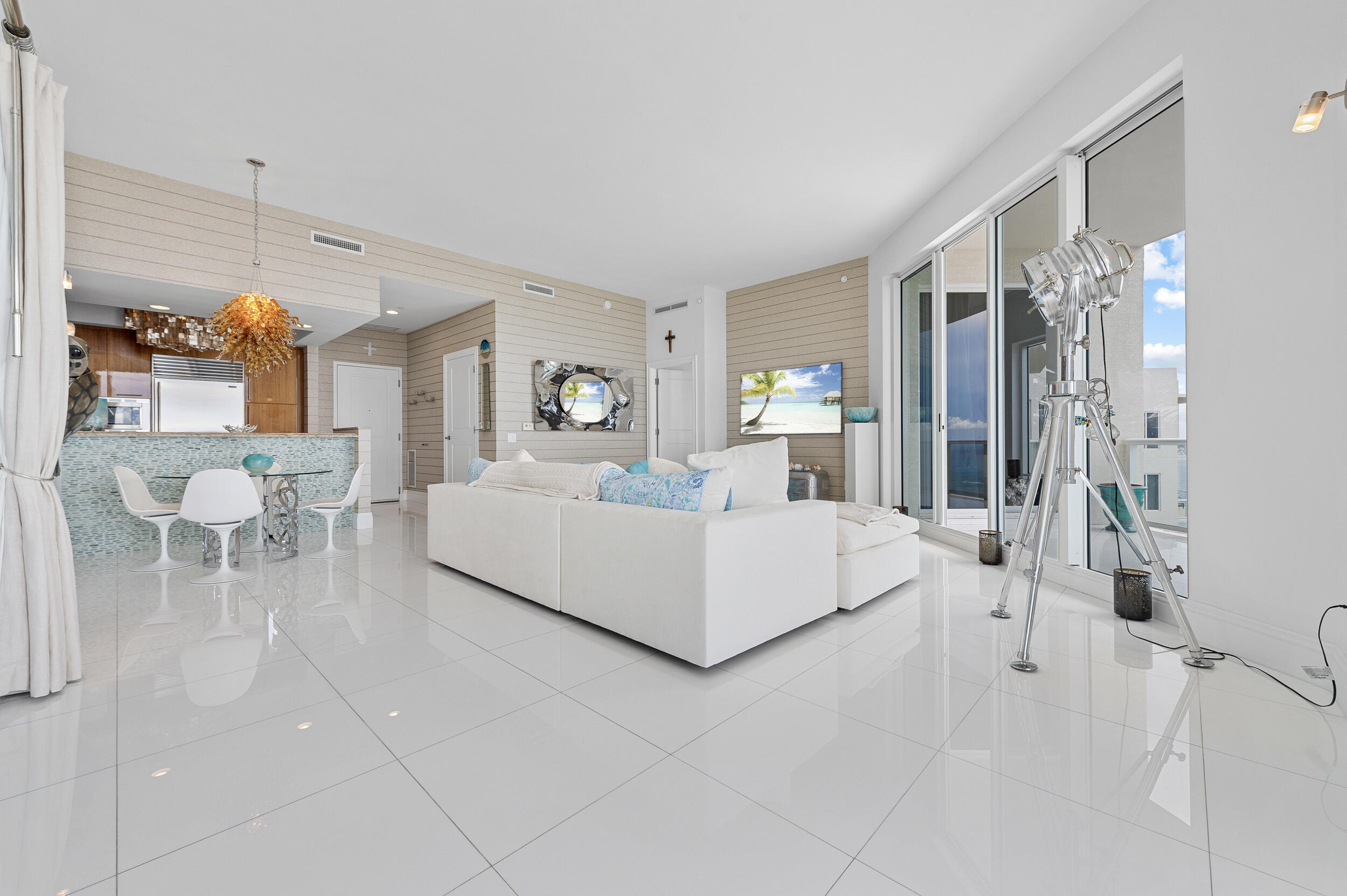 2700 North Ocean Drive, Unit PH4B Singer Island, FL 33404 - Photo 12 of 25 a living room with furniture and a chandelier