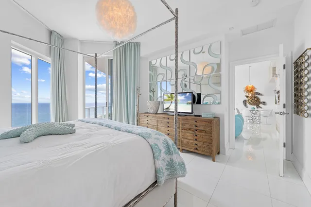 a spacious bedroom with a bed and a flat screen television