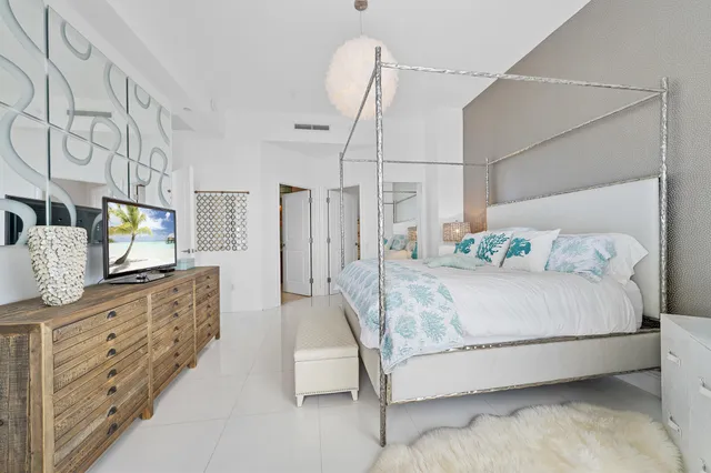 a bathroom with a tub a double vanity sink and large mirror