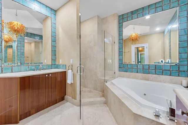 a spacious bathroom with a tub shower and a sink