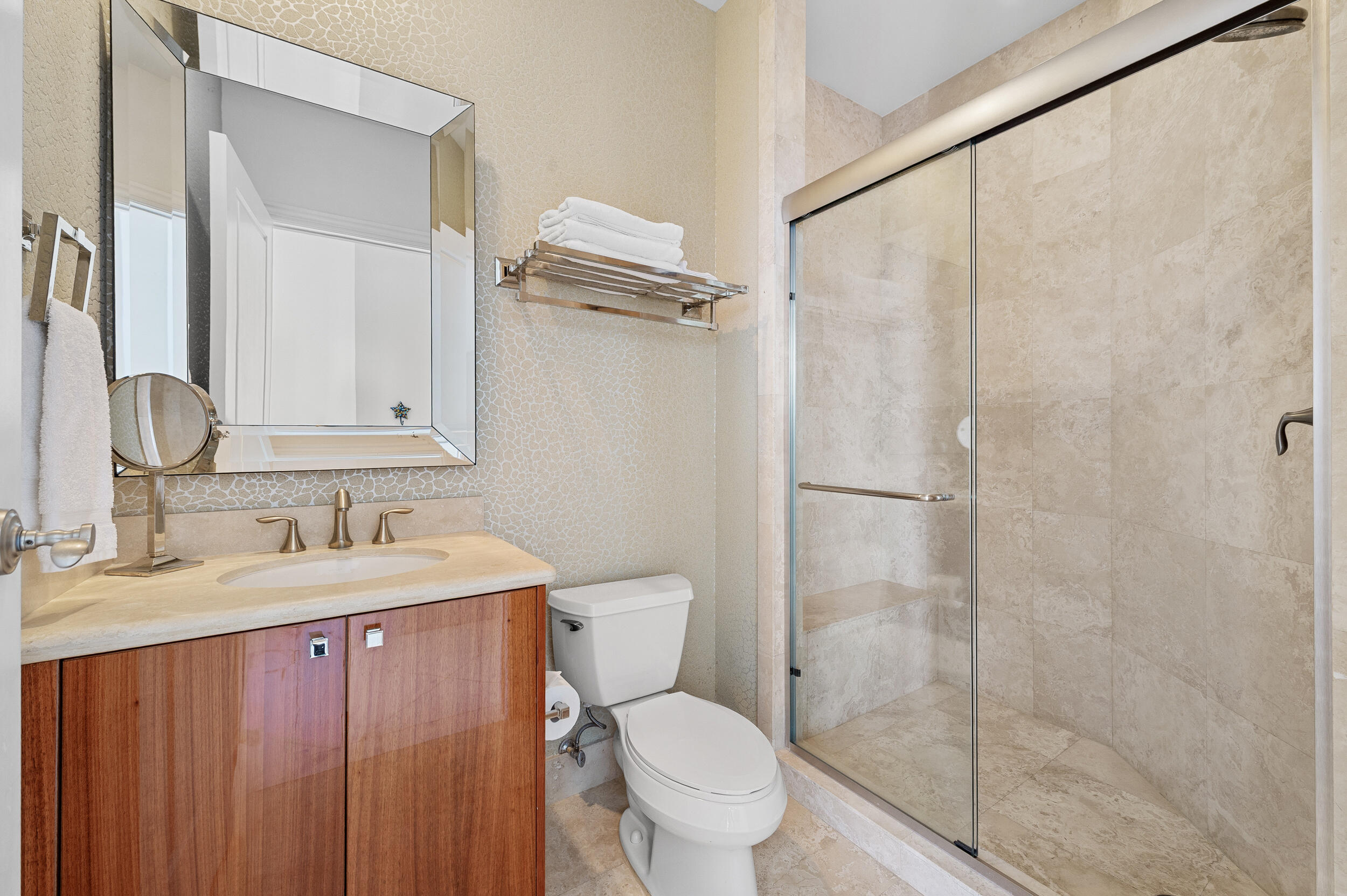2700 North Ocean Drive, Unit PH4B Singer Island, FL 33404 - Photo 23 of 25 a bathroom with a granite countertop sink toilet and shower