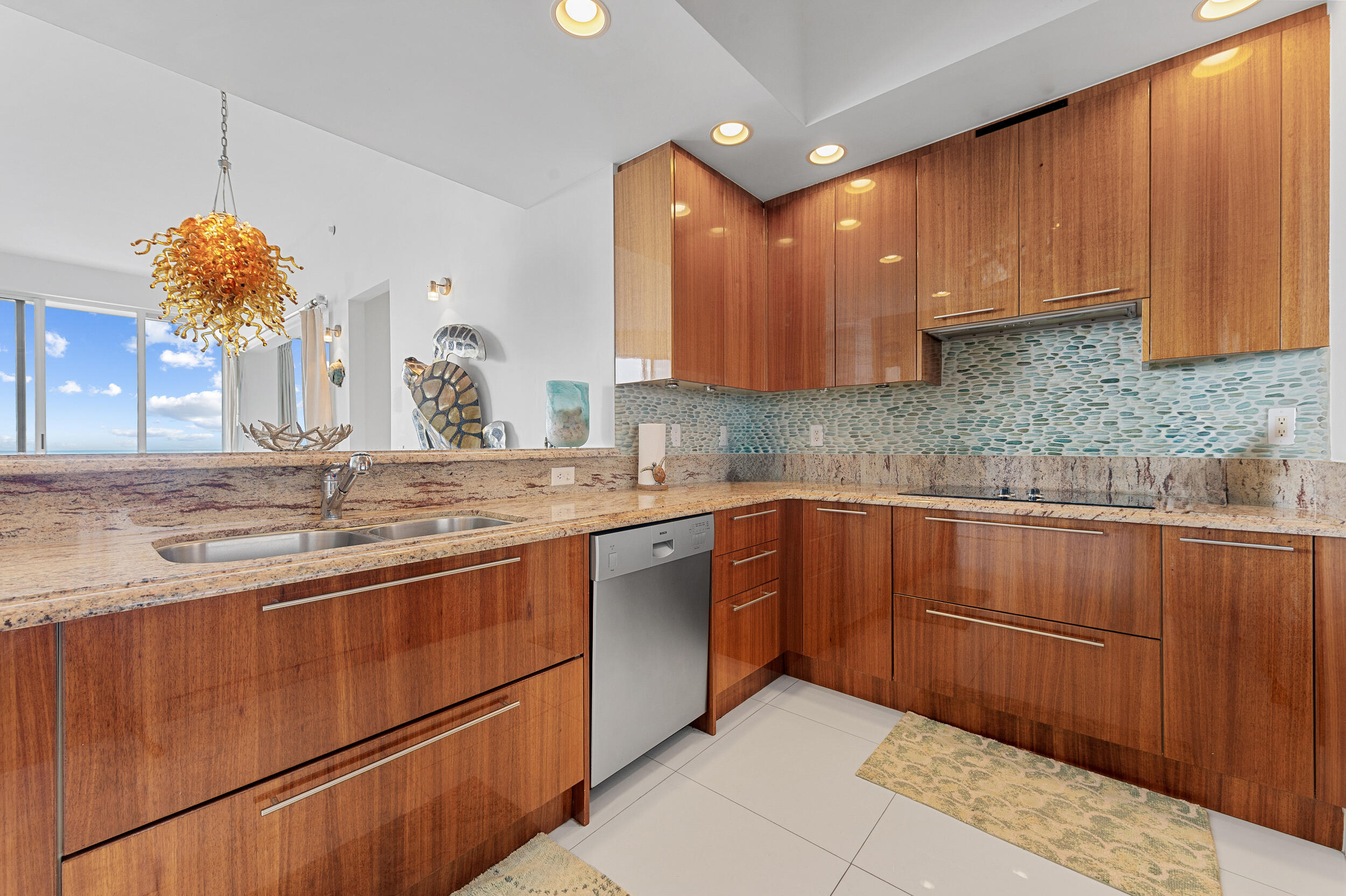 2700 North Ocean Drive, Unit PH4B Singer Island, FL 33404 - Photo 5 of 25 a kitchen with stainless steel appliances granite countertop a sink stove and cabinets