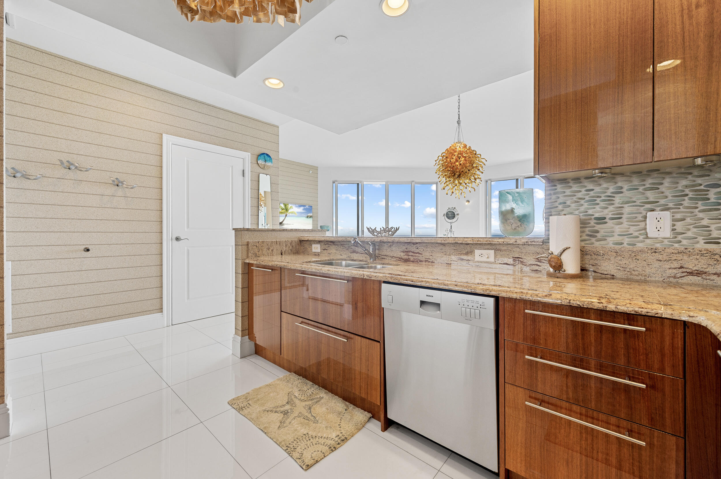 2700 North Ocean Drive, Unit PH4B Singer Island, FL 33404 - Photo 6 of 25 a kitchen with stainless steel appliances granite countertop a sink and cabinets