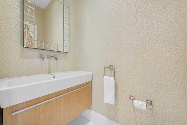 a bathroom with a sink a mirror and a toilet