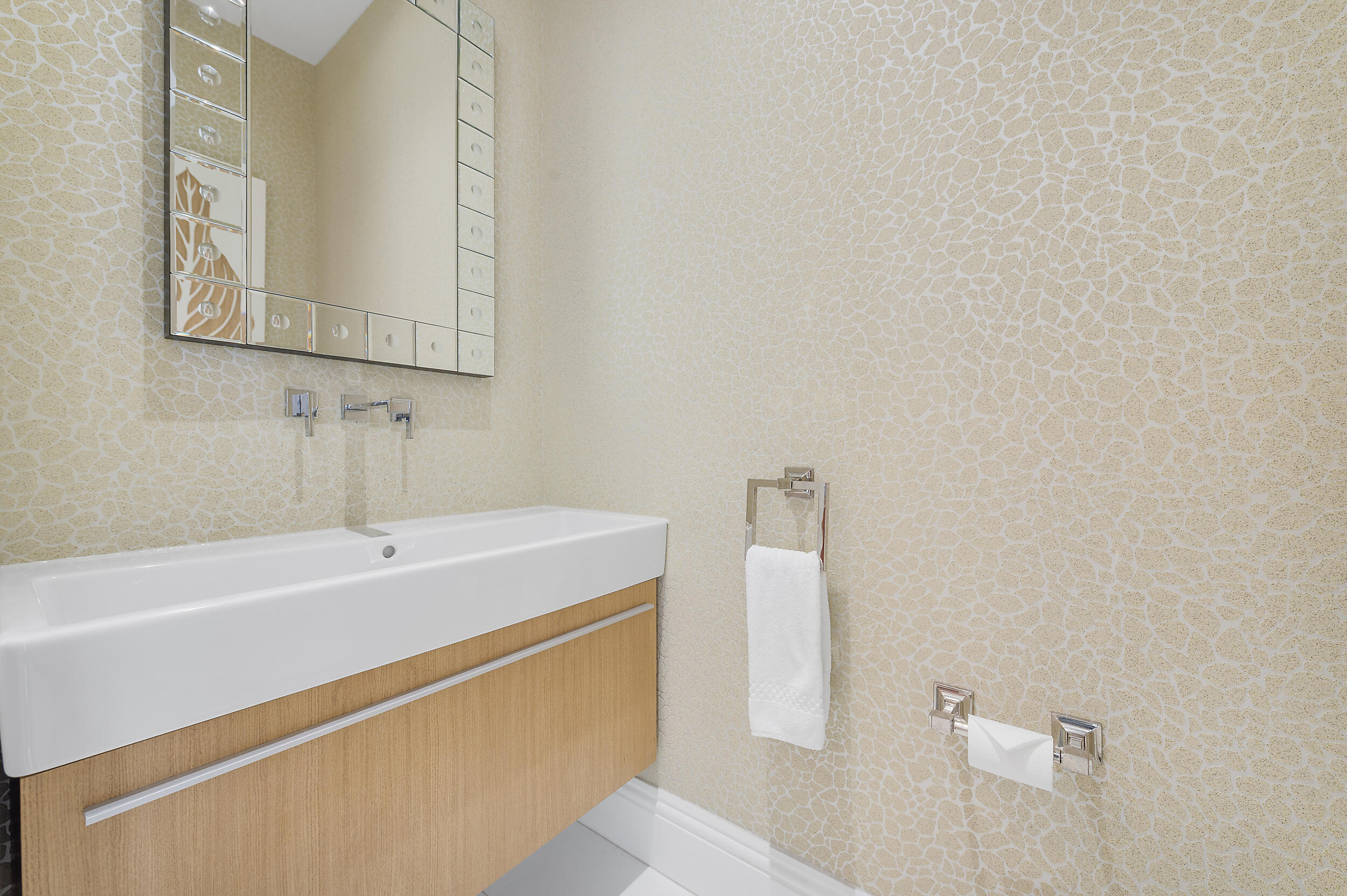 2700 North Ocean Drive, Unit PH4B Singer Island, FL 33404 - Photo 7 of 25 a bathroom with a sink a mirror and a toilet