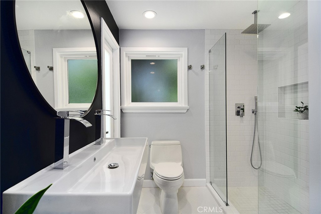 12427 Sunset Boulevard Los Angeles, CA 90049 - Photo 14 of 58 a bathroom with a toilet a sink and shower