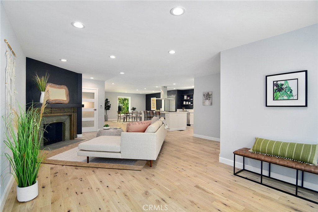 12427 Sunset Boulevard Los Angeles, CA 90049 - Photo 15 of 58 a living room with furniture a fireplace and a potted plant