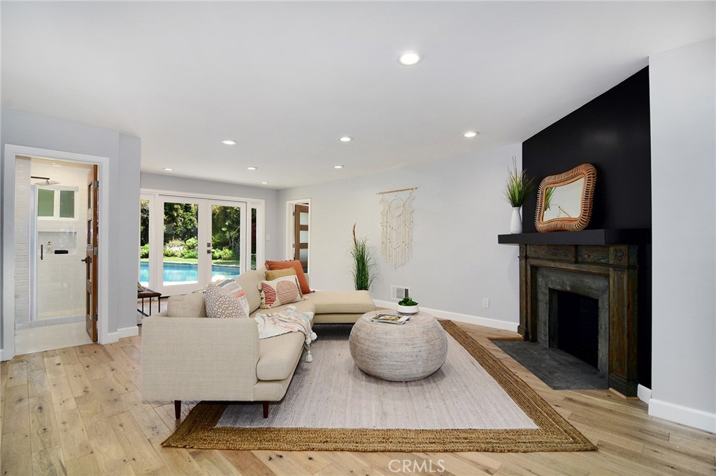 12427 Sunset Boulevard Los Angeles, CA 90049 - Photo 16 of 58 a living room with furniture a fireplace and a flat screen tv
