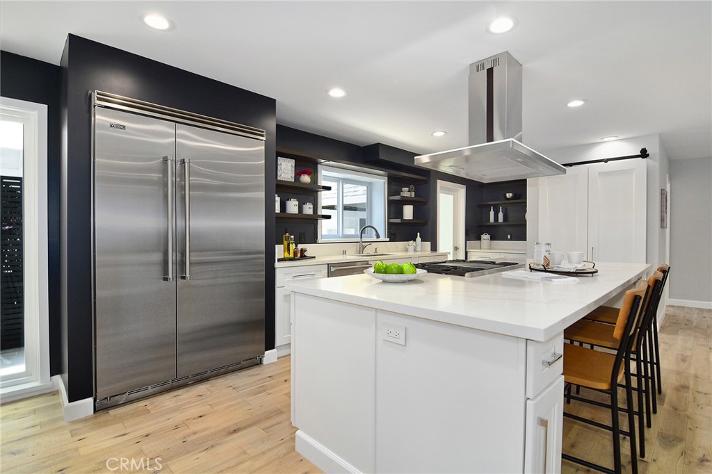 12427 Sunset Boulevard Los Angeles, CA 90049 - Photo 19 of 58 a kitchen with stainless steel appliances granite countertop a sink and a refrigerator