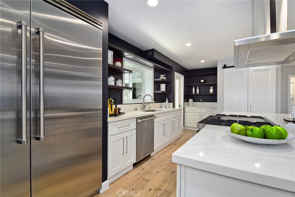 12427 Sunset Boulevard Los Angeles, CA 90049 - Photo 20 of 58 a kitchen with stainless steel appliances granite countertop a sink and a refrigerator