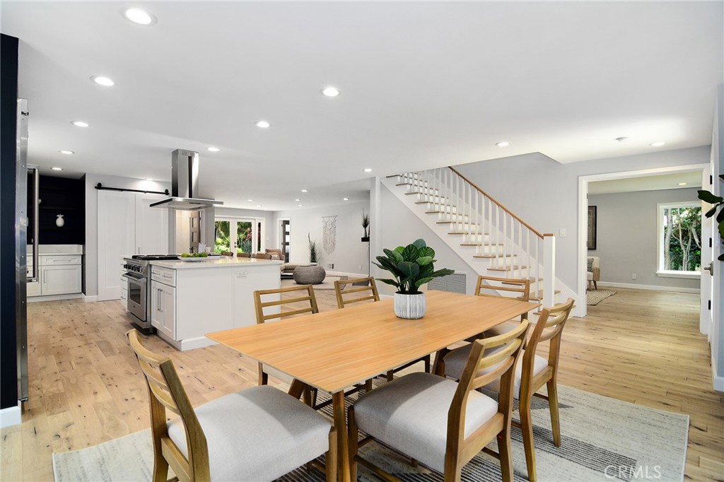 12427 Sunset Boulevard Los Angeles, CA 90049 - Photo 22 of 58 a view of a dining room with furniture and wooden floor