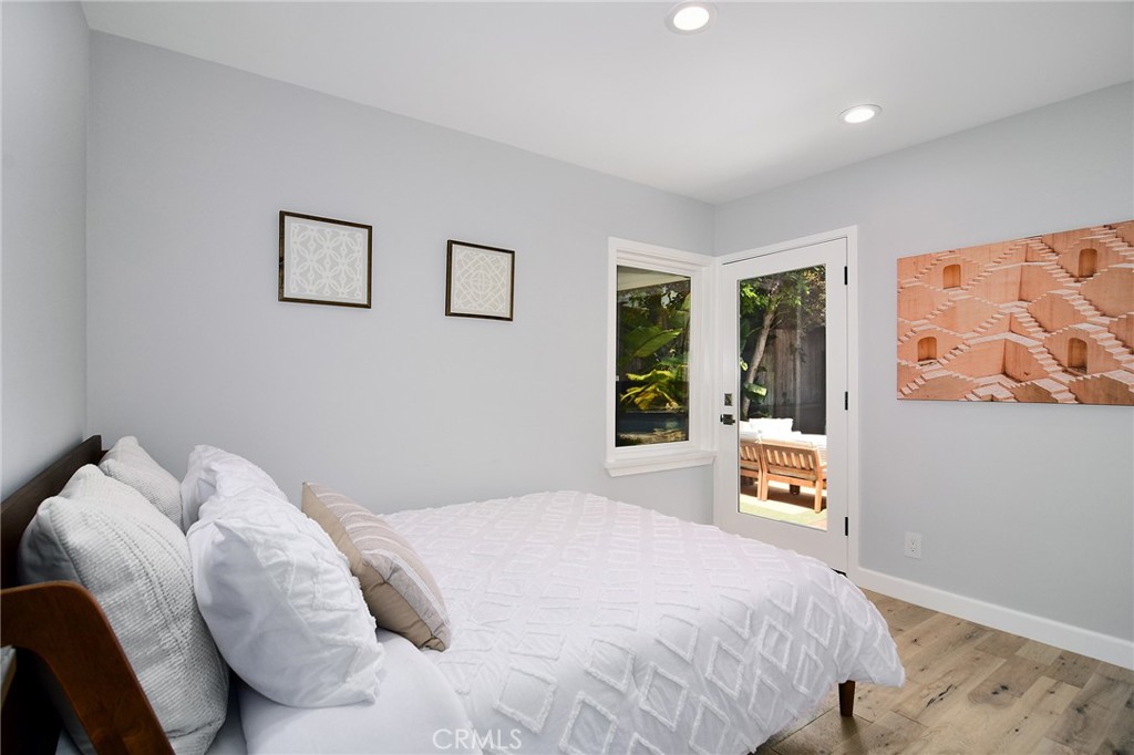 12427 Sunset Boulevard Los Angeles, CA 90049 - Photo 24 of 58 a bedroom with a bed and a painting on the wall