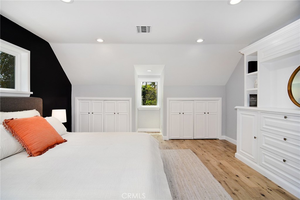 12427 Sunset Boulevard Los Angeles, CA 90049 - Photo 28 of 58 a bedroom with a large bed and a dresser