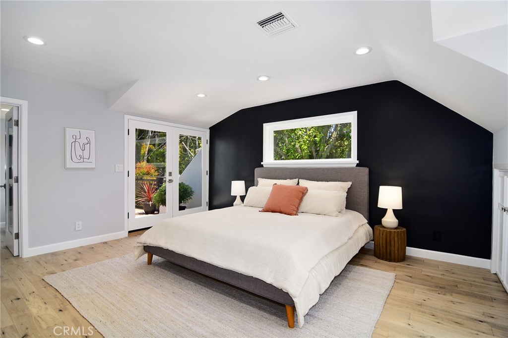 12427 Sunset Boulevard Los Angeles, CA 90049 - Photo 29 of 58 a large bedroom with a bed and a flat tv screen on dresser