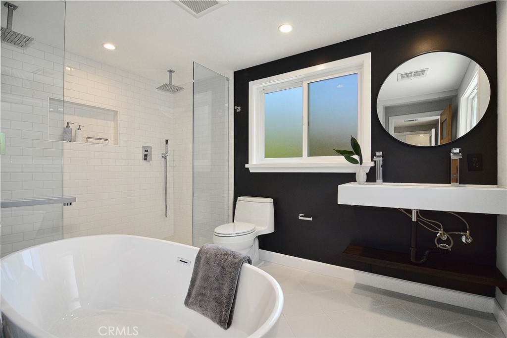 12427 Sunset Boulevard Los Angeles, CA 90049 - Photo 35 of 58 a bathroom with a sink a toilet and a mirror